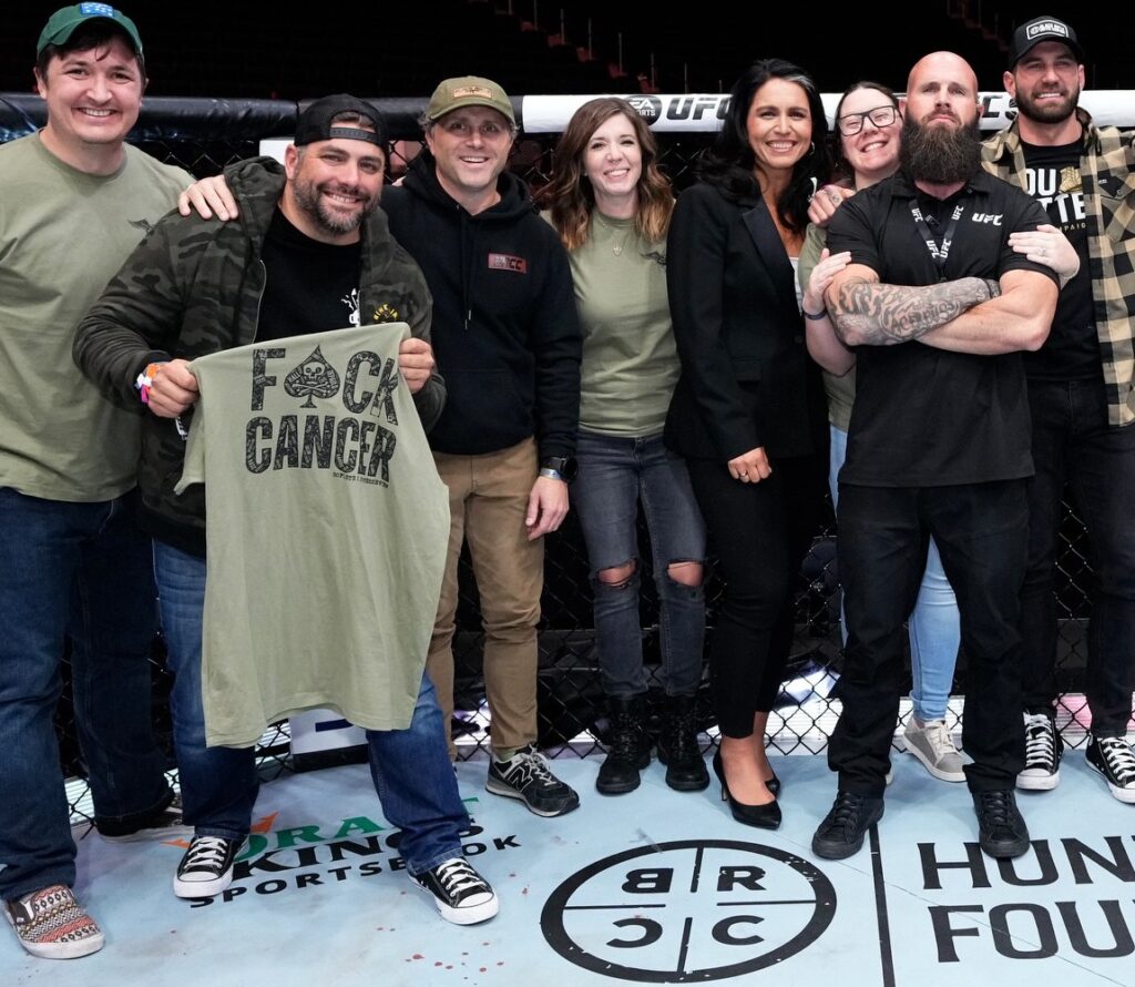 From left to right: HunterSeven Foundations Director of Education, Jack Ratliff; BRCC's Jarred Taylor and Evan Hafer, Director of Immediate Needs, Jillian Rowe, Army veteran and former Congresswoman Tulsi Gabbard, Founder of HunterSeven, Chelsey Simoni, UFC Head of Security and Army veteran, Elliott Loewenstein, and BRCC's Mat Best at UFC 295 in New York City.